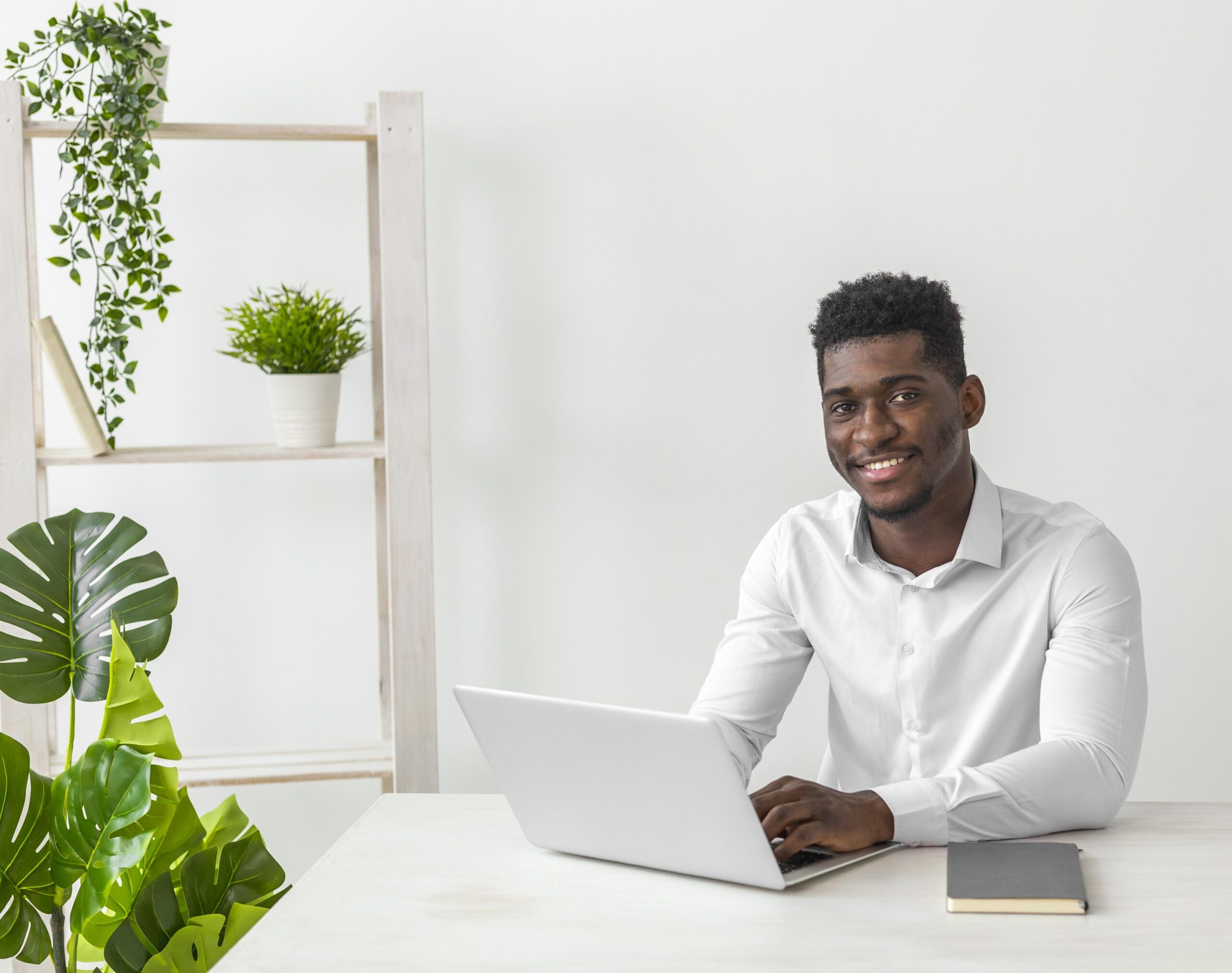 african-american-man-sitting-desk-smiles